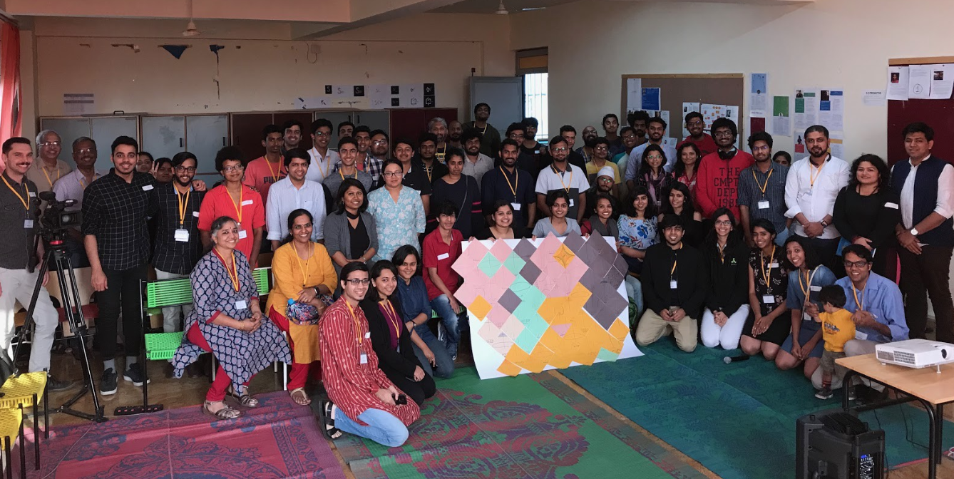 A group picture of the participants of PCD Bangalore — group of people in the center are holding the “Data Selfie” installation